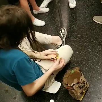 Just a man and his nuggets man on floor eating