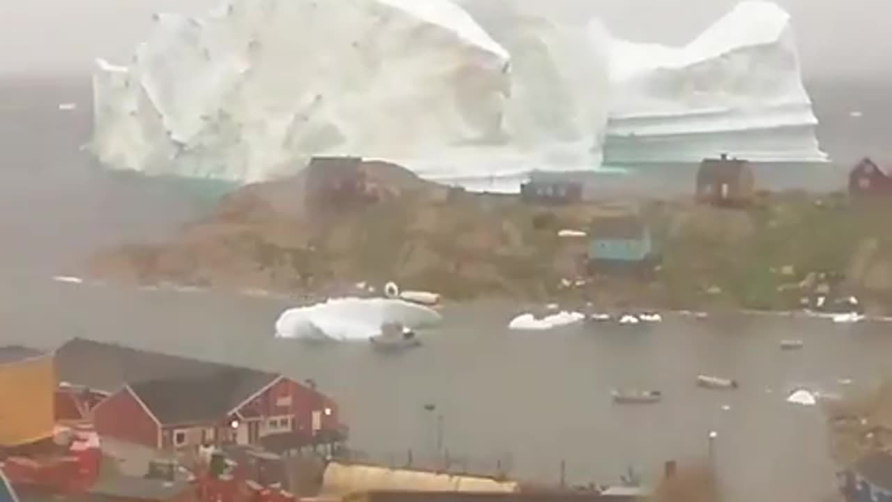 Incredible timelapse of a massive iceberg drifting past Innaarsuit village in Greenland!