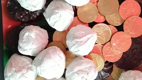 Unpacking marshmallows, kinder surprise. Chocolate coins.