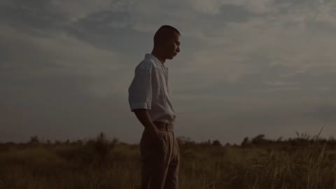 Sad handsome guy on the grass