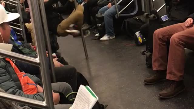 Ponytail guy dances on pole in subway