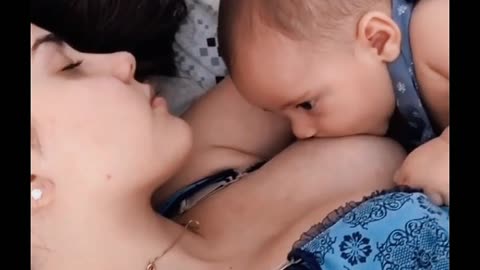 Cute baby sleeping with his mom.