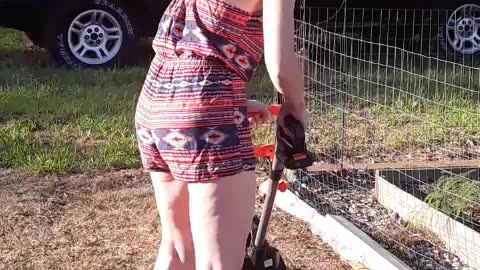 Redhead in a romper tilling