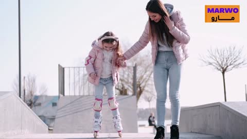 A mother teaches her daughter to walk on a calf