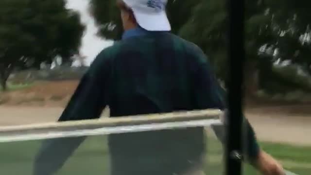 Golf cart runs into guy white cap