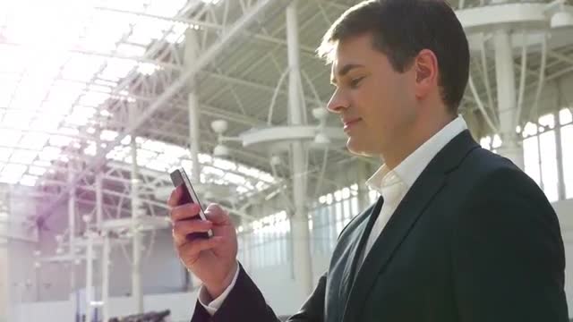 Handsome smiling young man under the steel structure