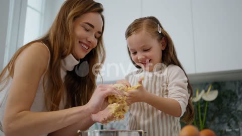 Funny baby playing dough at cook place close up