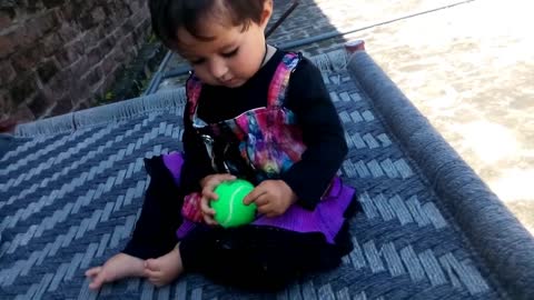 A very Cute baby Playing with Tennis Ball