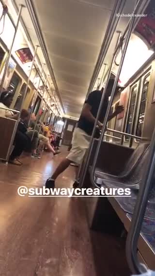 A man in black shirt hat growls like dog on subway
