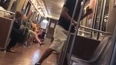 A man in black shirt hat growls like dog on subway