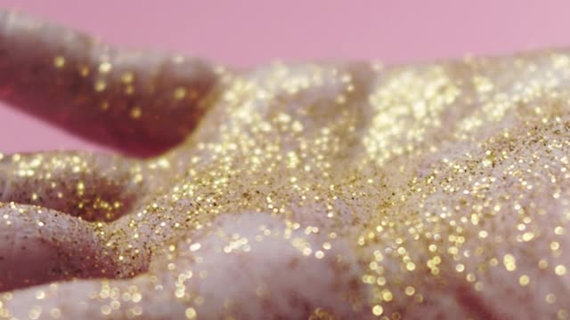 Palm Of A Hand Full Of Gold Glitters