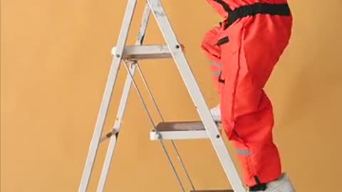 Two Kids in a Spacesuit Costume Climbing Up a Ladder