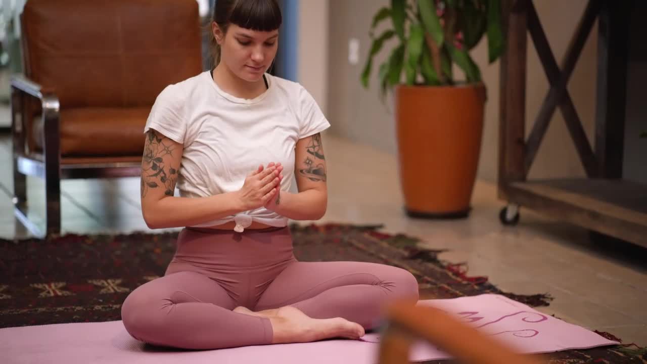 Young woman practicing yoga on her living room floor