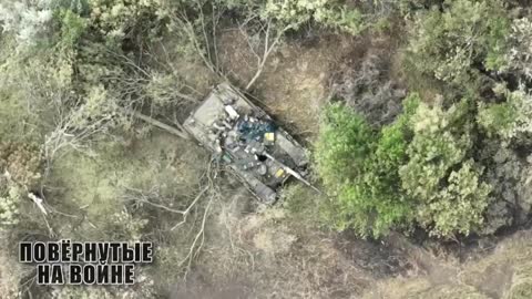 Russian troops finish off a T-64BV by throwing grenades into the open hatches