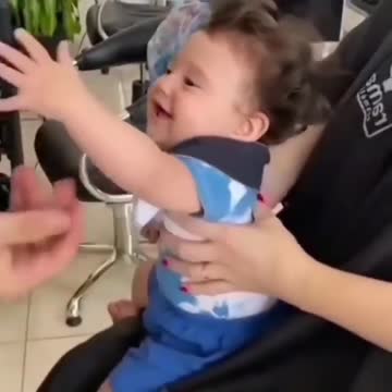 Cute baby cutting her hair