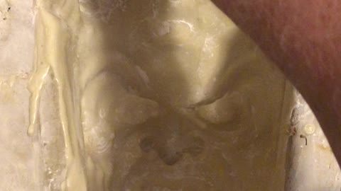 Pulling a latex Krampus mask from mold one handed