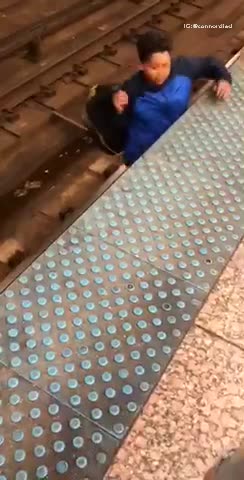 Two boys sneak into subway and walk across subway rails