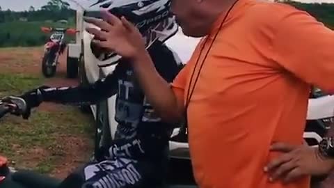 father giving motocross tips to son