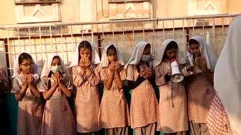 Little girls are praying in school