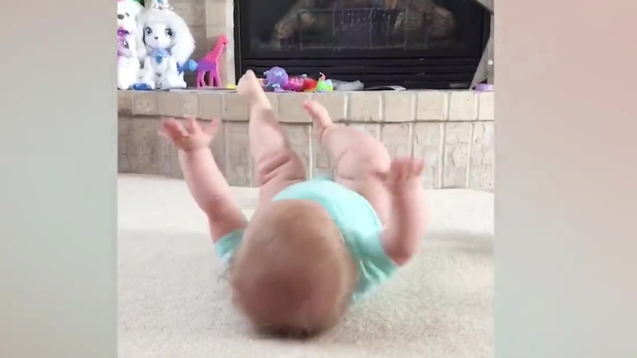 Babies smiling and playing on their own.