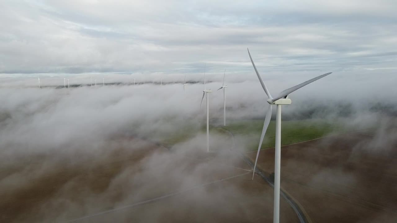 wind power plant looking so beautiful above the clouds