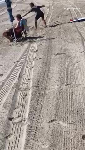 Guy practices surf moves on the sand before hitting the waves