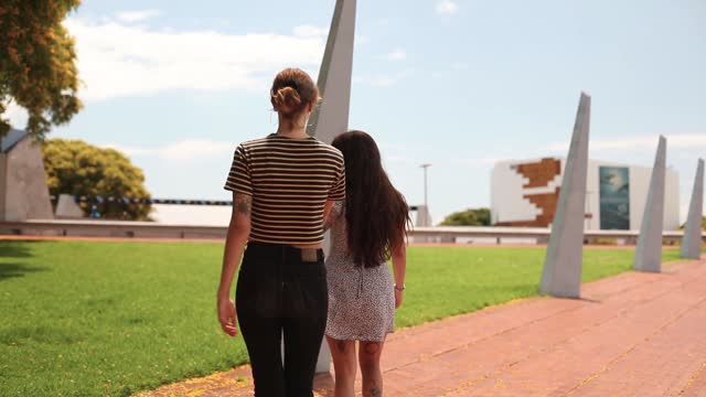 Women holding hands outdoors