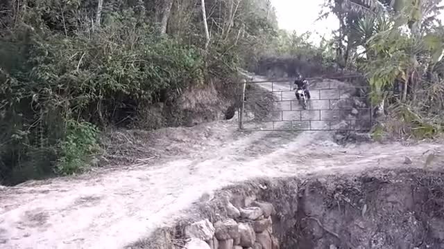 A motorcyclist avoids a barrier