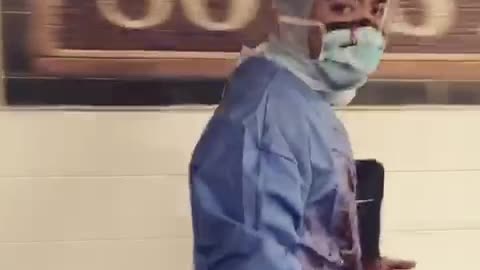 Man in surgeon doctor outfit with blood all over