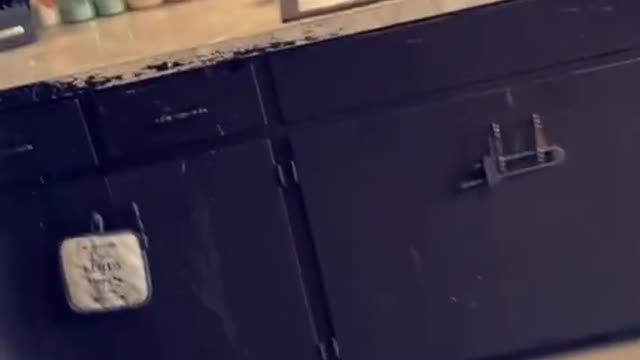 Toddler Taking Bath While Sitting in Kitchen Sink Sprays Water all Around by Moving Faucet