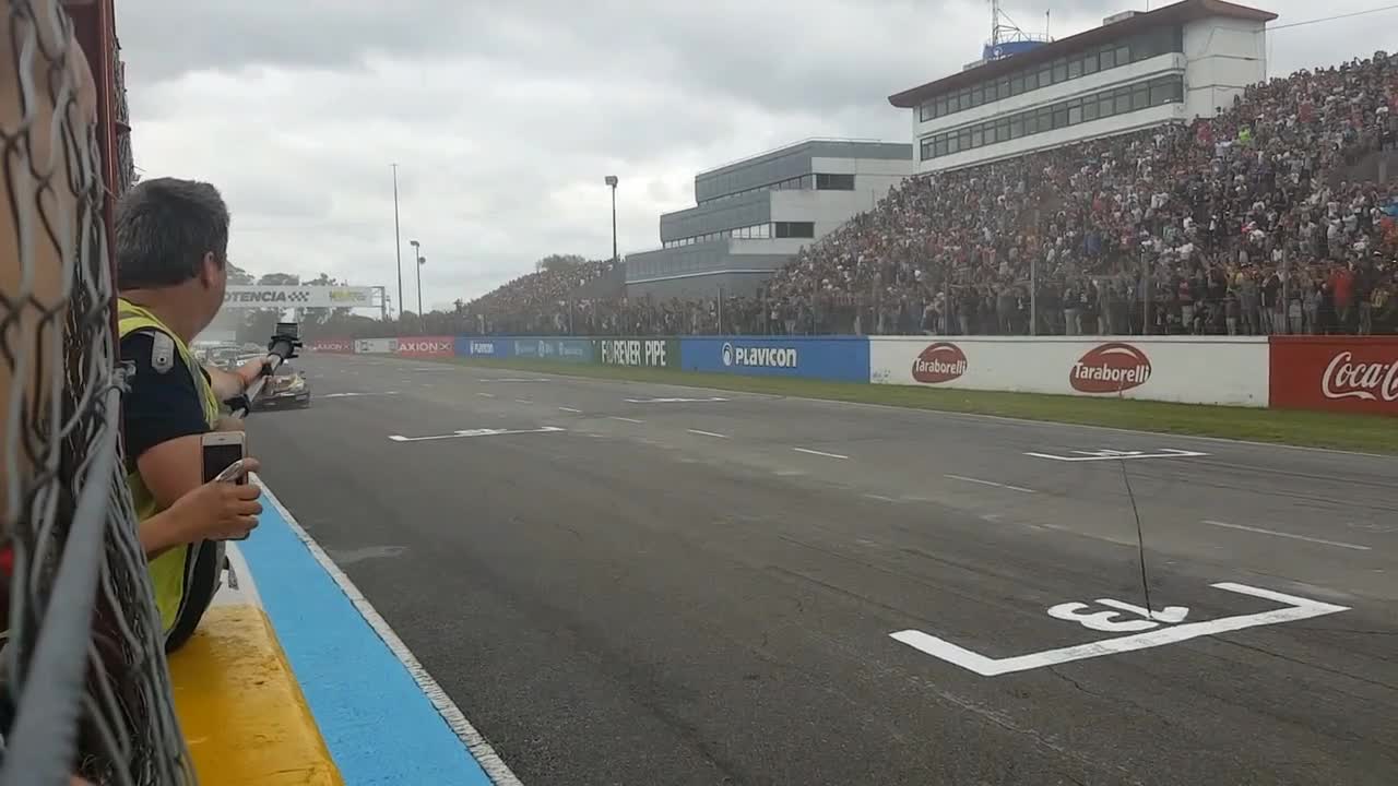 Racing cars passing people in full speed