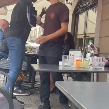 African immigrant puts her hands around neck of an Italian waitress who was simply doing her job
