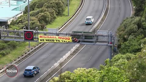 Rail protesters climb Wellington motorway gantry, shut down SH1