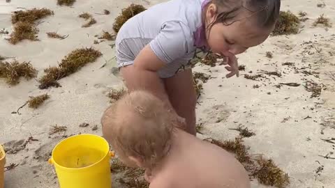 Naomi washes the sand off David. Cute Baby video!