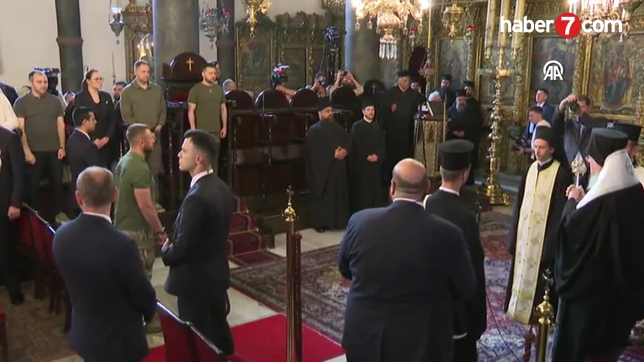 Zelensky, wearing a t-shirt, stands in front of Bartholomew's throne