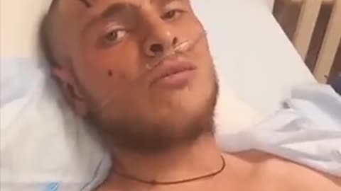 A Russian talking from his Ukrainian hospital bed after being taken prisoner talks