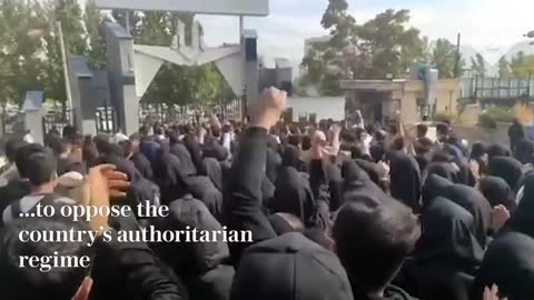 University security guards protect students in Sanandaj as Iranian security forces fire shots