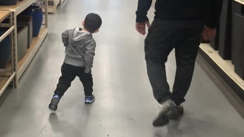 Little Boy Practices Walking Like Dad