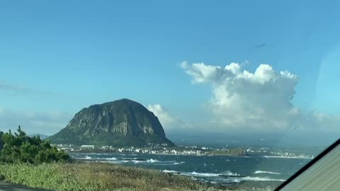 A wonderful mountain and a cool sea. It's Jeju Island, Korea.
