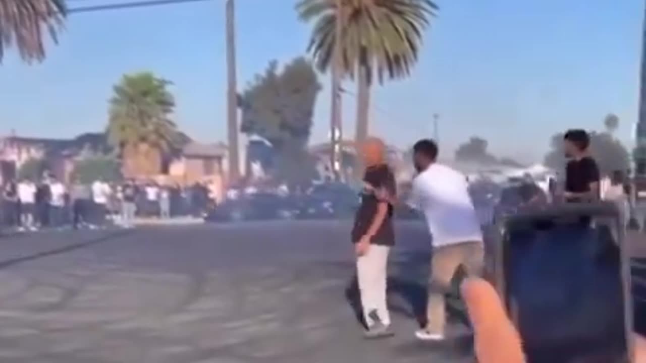 Man gets pocket checked and slapped after being hit by a car doing donuts