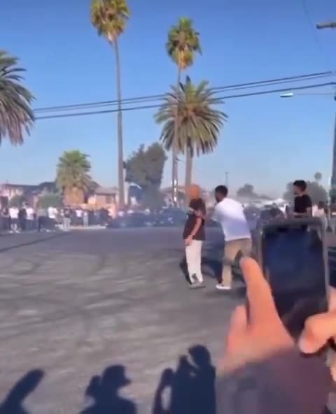 Man gets pocket checked and slapped after being hit by a car doing donuts