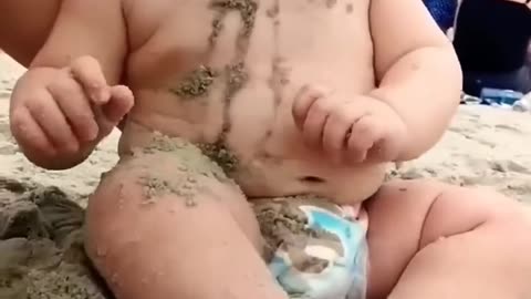 Funny baby reaction on the beach