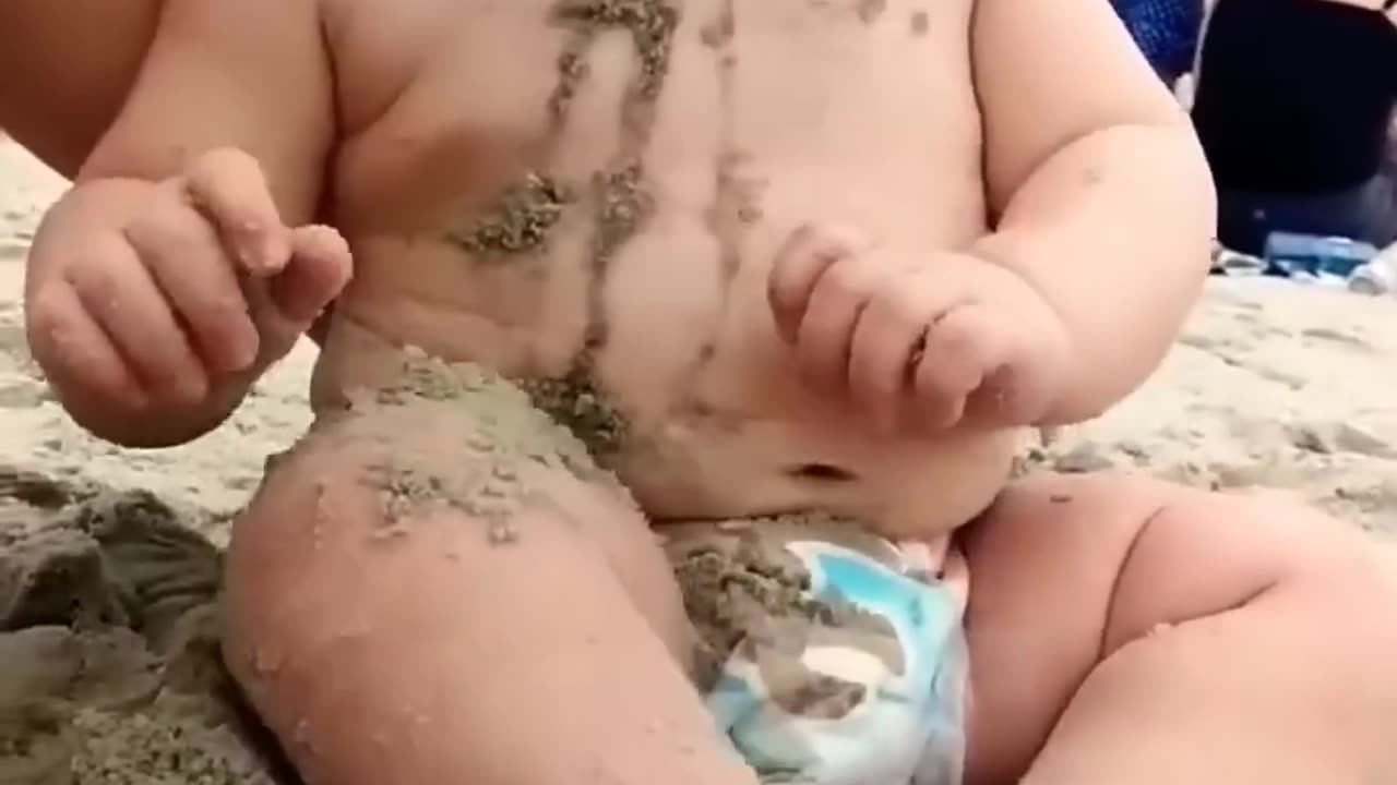 Funny baby reaction on the beach