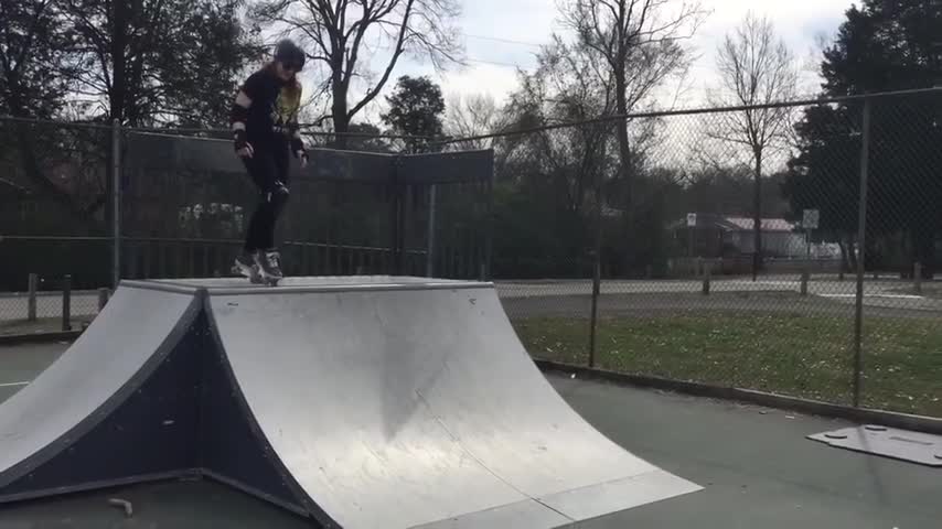 Girl Tries to Master Trick on Quarter Pipe