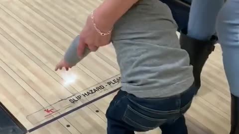 Toddler and Grandma Take a Tumble While Bowling