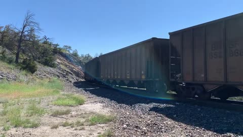Solid EMD SD70ACe lineup up Mullan Pass. 3 BNSF, 4 MRL, then 1 BNSF on the rear.