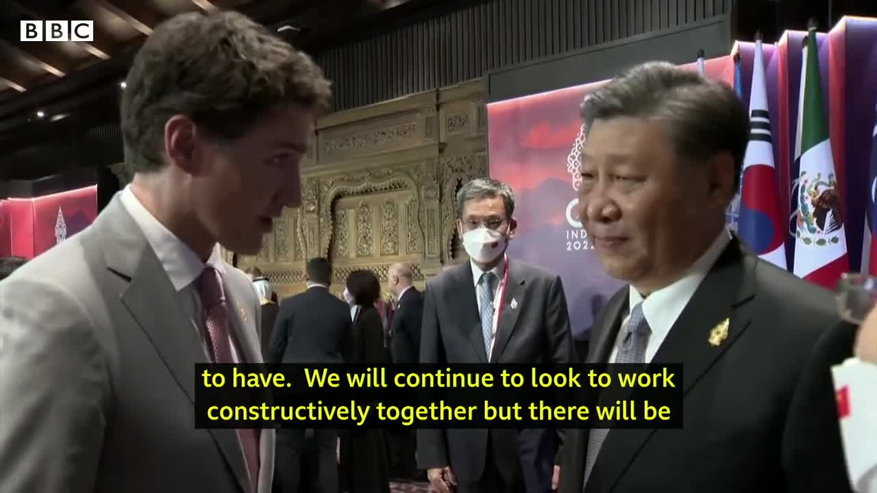 China and Canada leaders caught having tense exchange on camera - BBC News