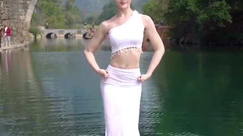 A beautiful girl dance on river side