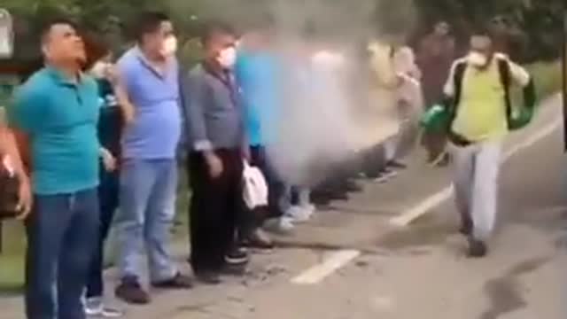 Ecuador Covid Protection, disinfecting passengers before entering the bus