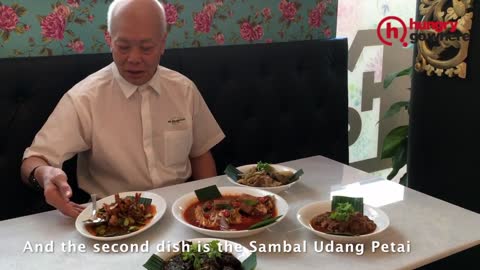 Funny waiter at a Peranakan restaurant in Singapore